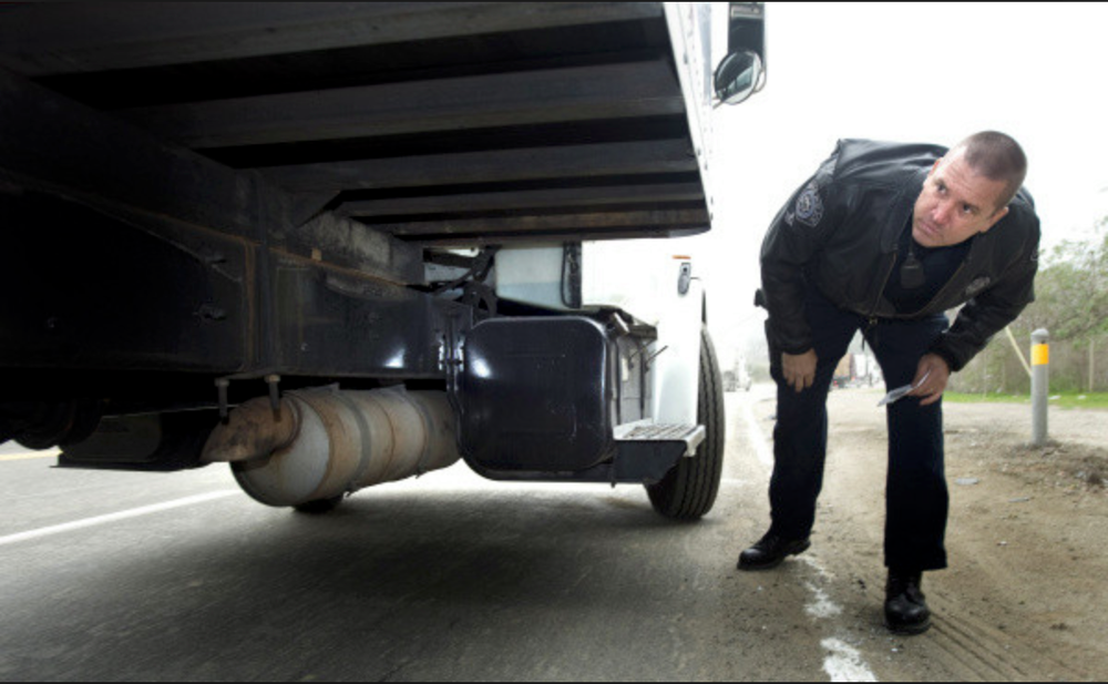 officer-inspecting-turck