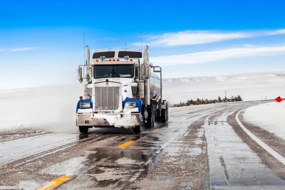 truck-driving-on-icy-road-with-frost-laws